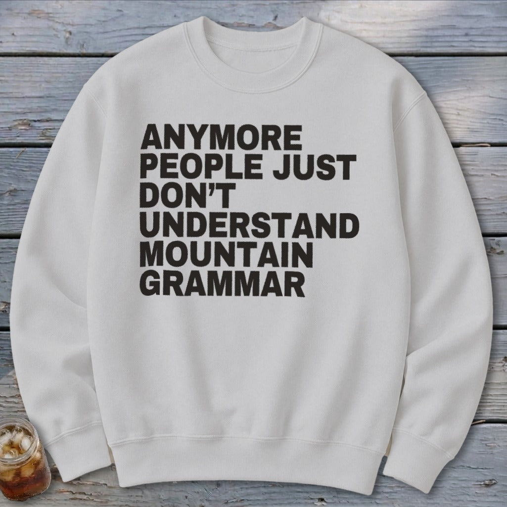 White crewneck sweatshirt with black text: "Anymore People Just Don't Understand Mountain Grammar."