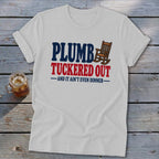 White t-shirt with "PLUMB TUCKED OUT AND IT AIN'T EVEN DINNER" text and rocking chair graphic.