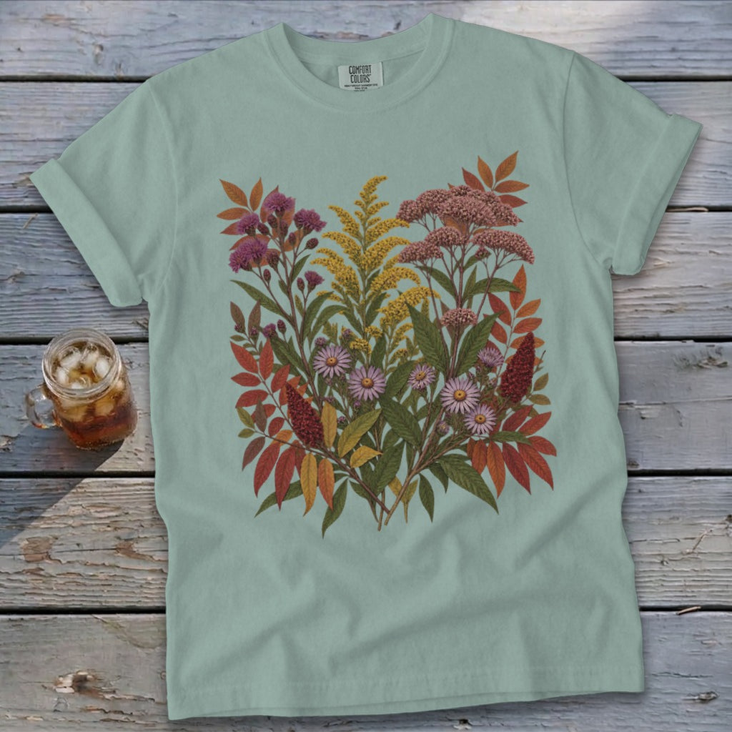 Light blue t-shirt with a dense floral and foliage print in autumn colors.