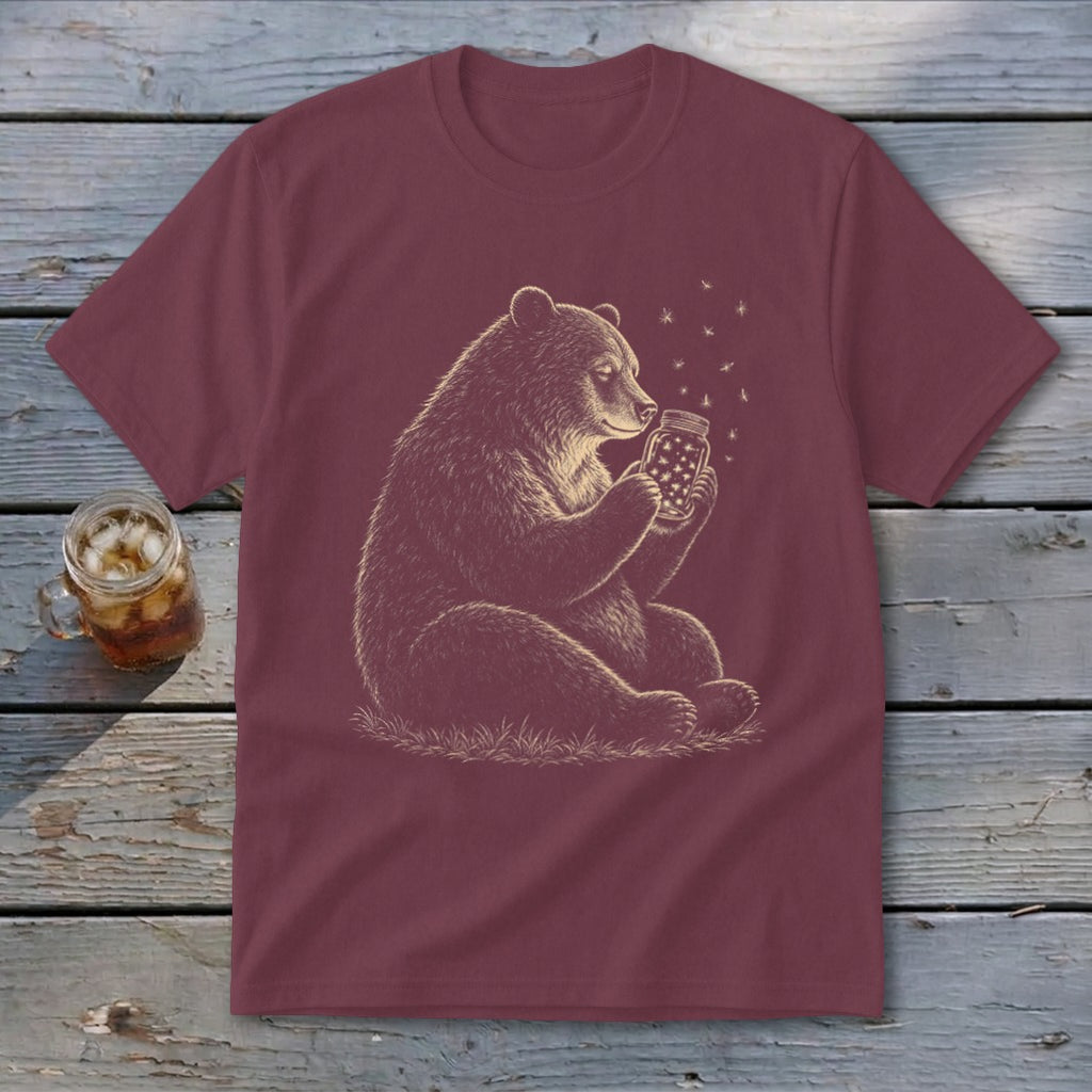 Maroon t-shirt with illustration of a bear holding a jar of fireflies.