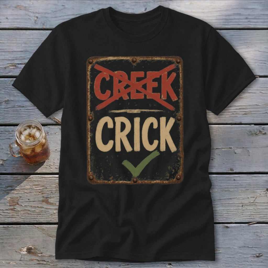 Black t-shirt with a distressed sign graphic reading "CREEK" crossed out and "CRICK" with a checkmark.