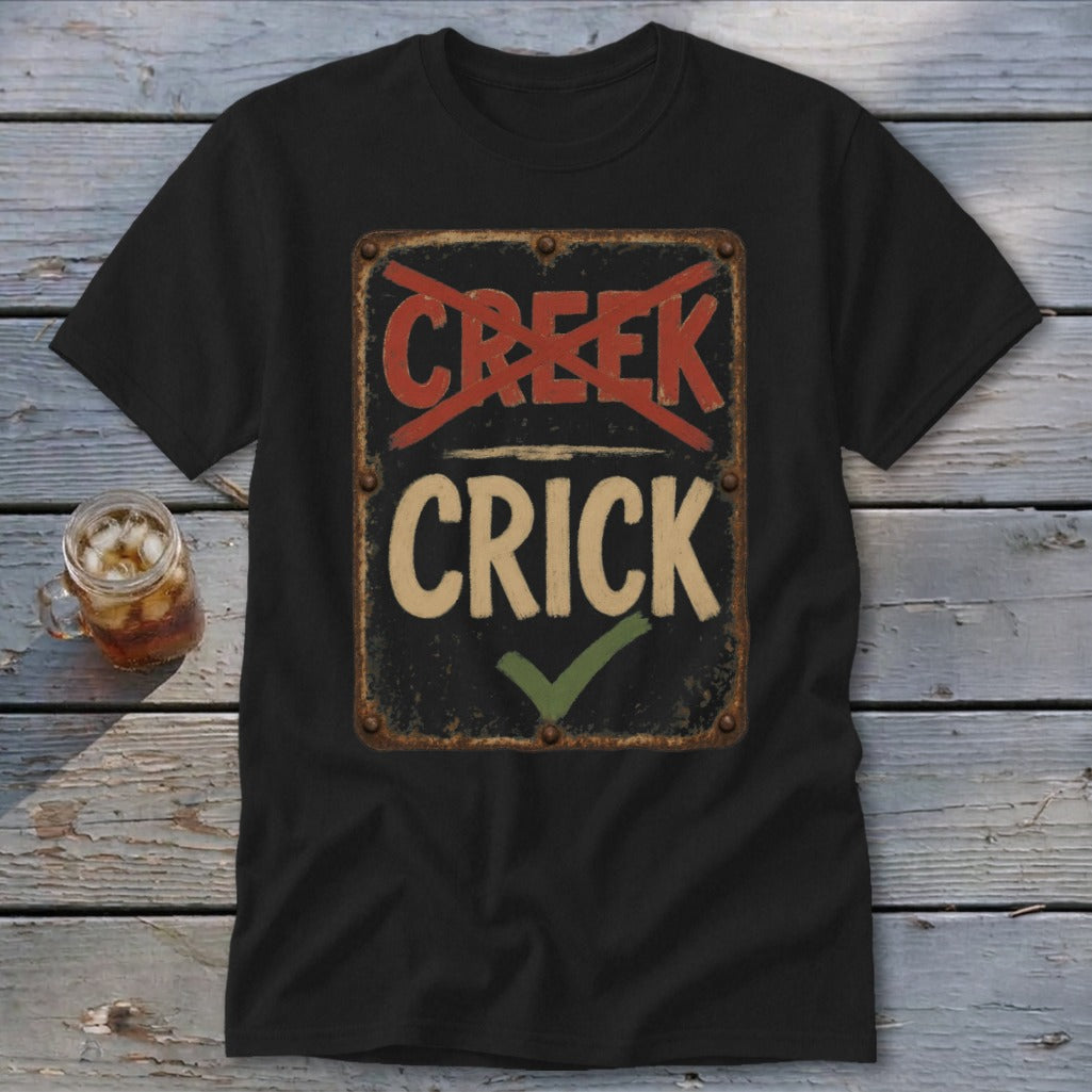 Black t-shirt with a distressed sign graphic reading "CREEK" crossed out and "CRICK" with a checkmark.