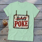 A light green t-shirt featuring a distressed wooden sign graphic with crossed-out text reading Bag Poke.