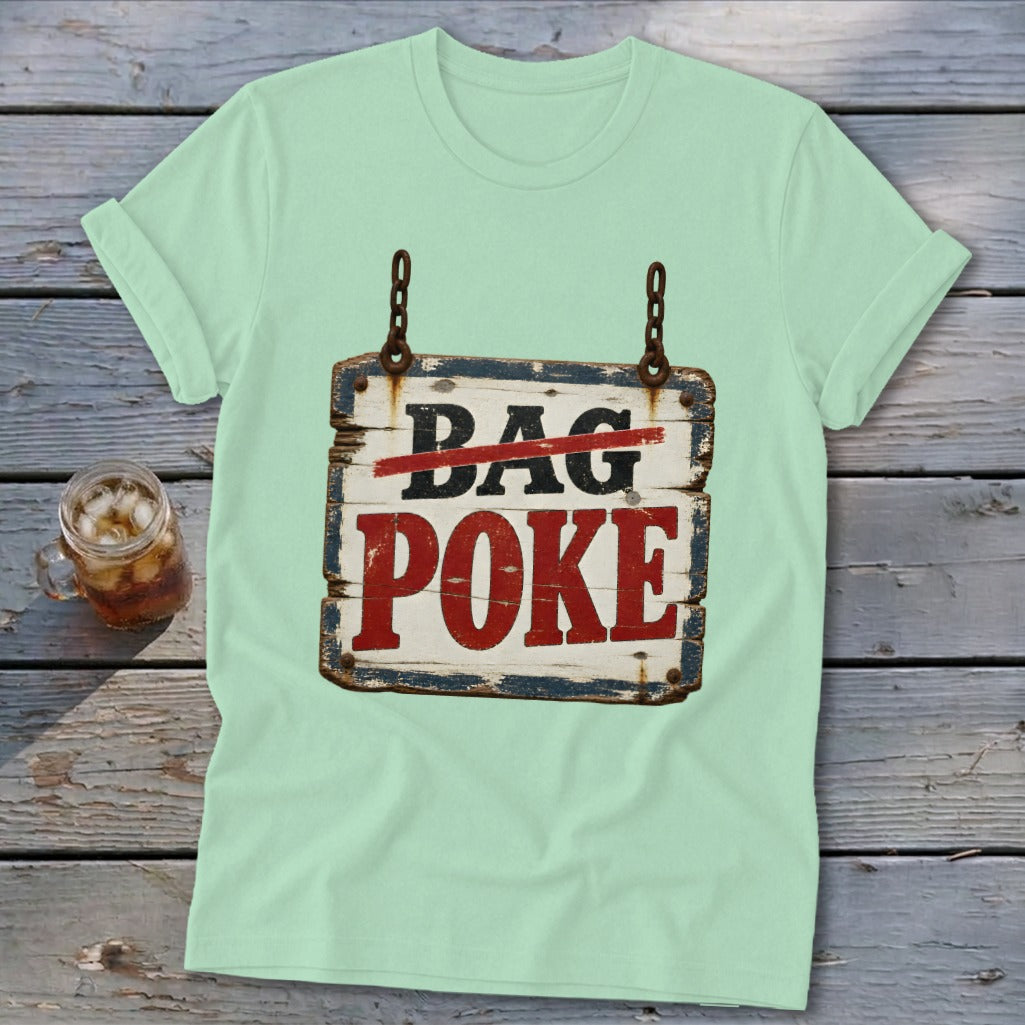 A light green t-shirt featuring a distressed wooden sign graphic with crossed-out text reading Bag Poke.