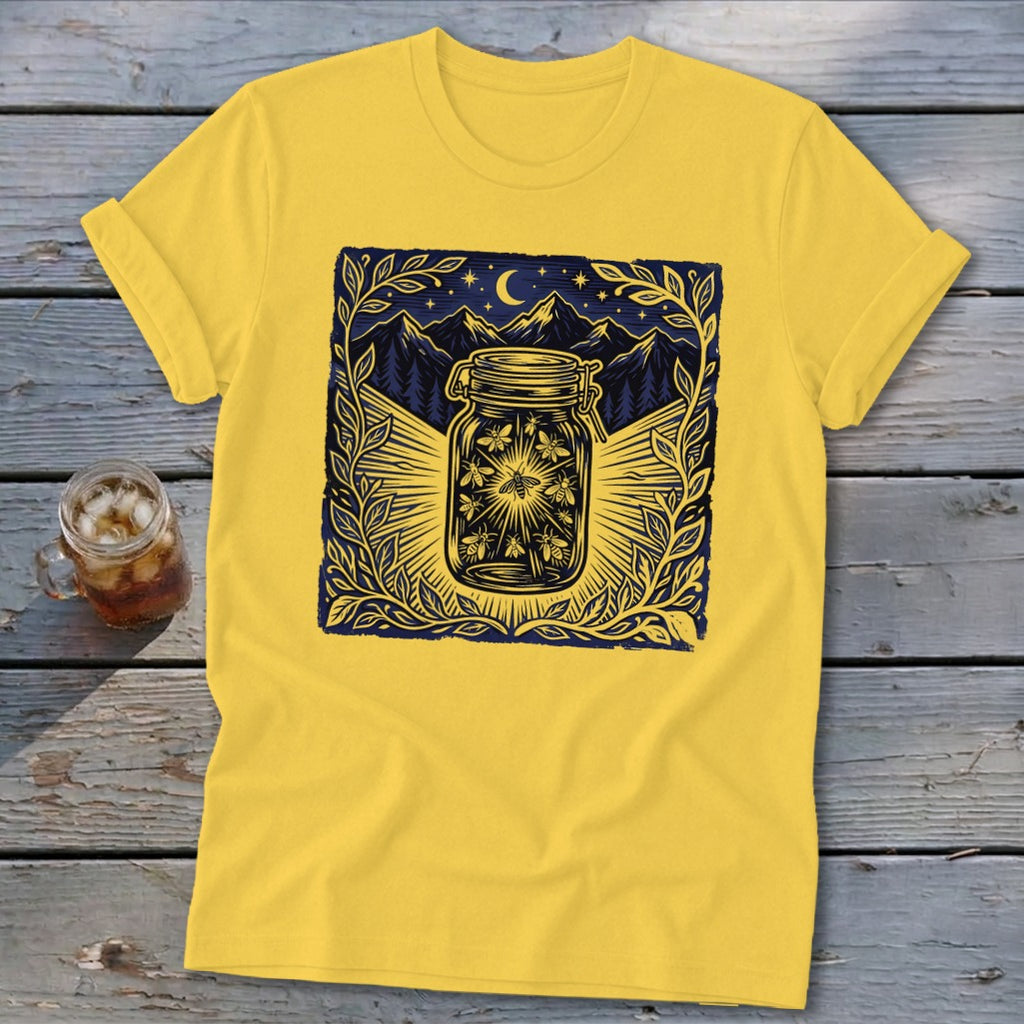 Yellow t-shirt with a graphic of fireflies in a jar under a starry night sky.