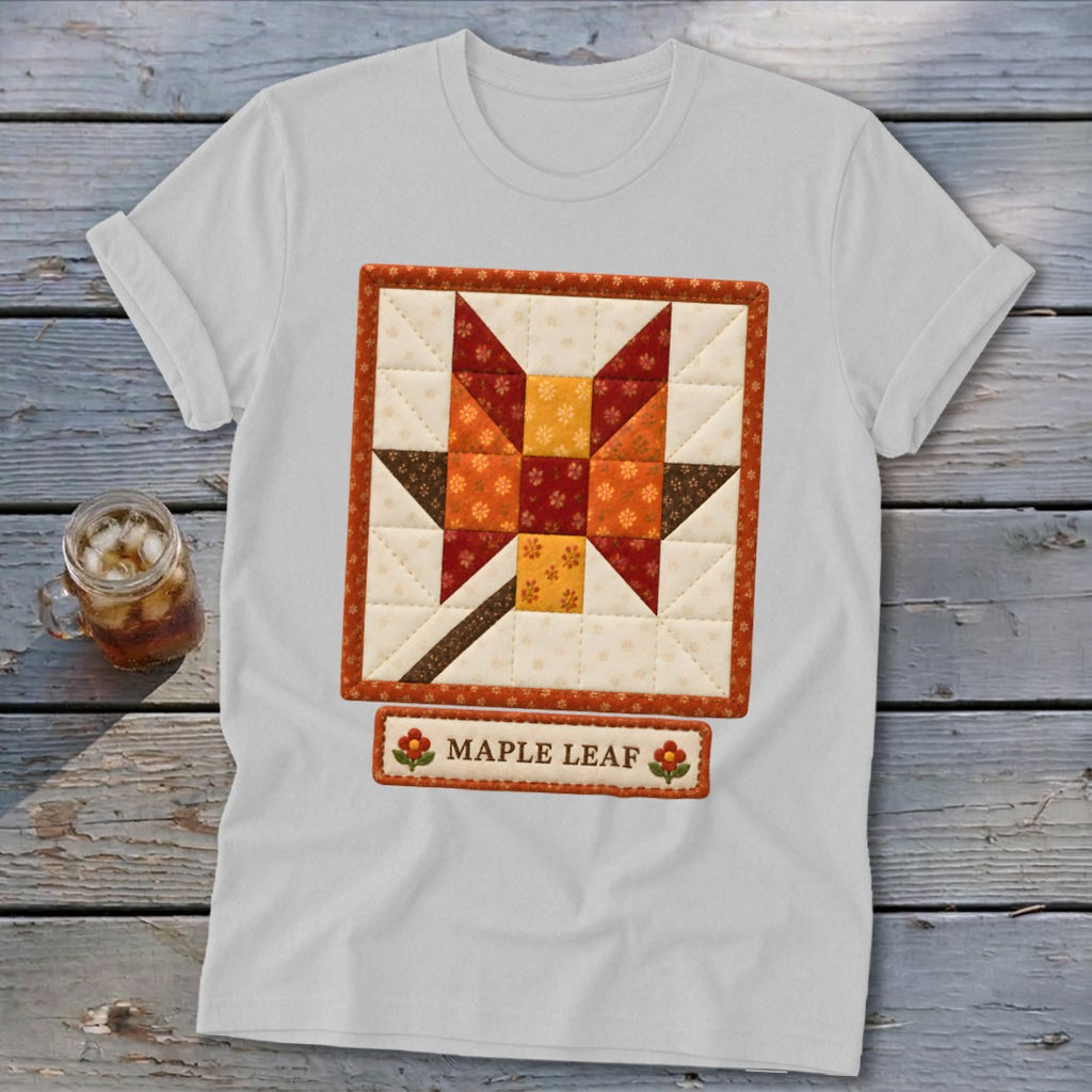 White t-shirt with a quilted maple leaf design and "Maple Leaf" text.