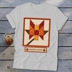 White t-shirt with a quilted maple leaf design and "Maple Leaf" text.