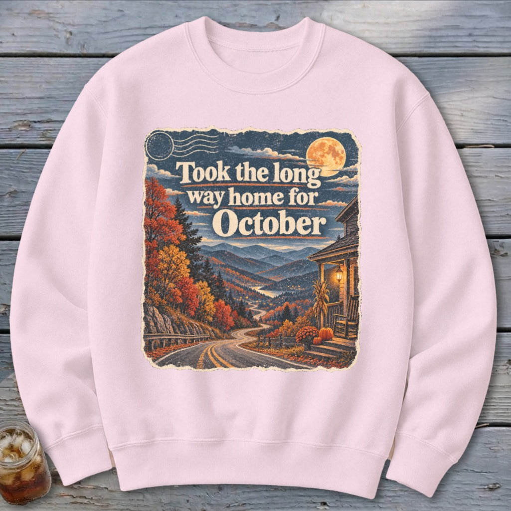 Pink sweatshirt with "Took the long way home for October" text and autumn mountain landscape.