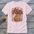 Pink t-shirt featuring a wooden barrel overflowing with sorghum stalks, with the word "Sorghum" in script.
