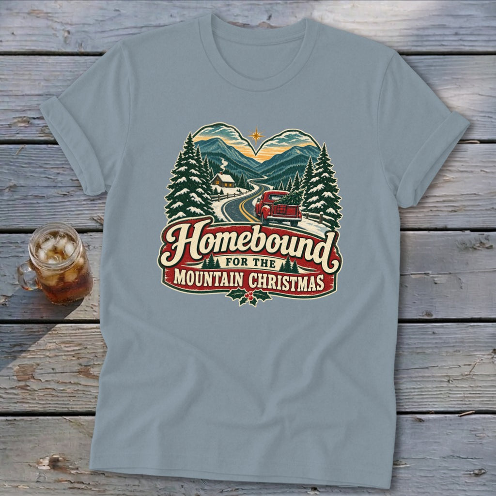 T-shirt with "Homebound for the Mountain Christmas" graphic featuring a red truck and snowy mountains.