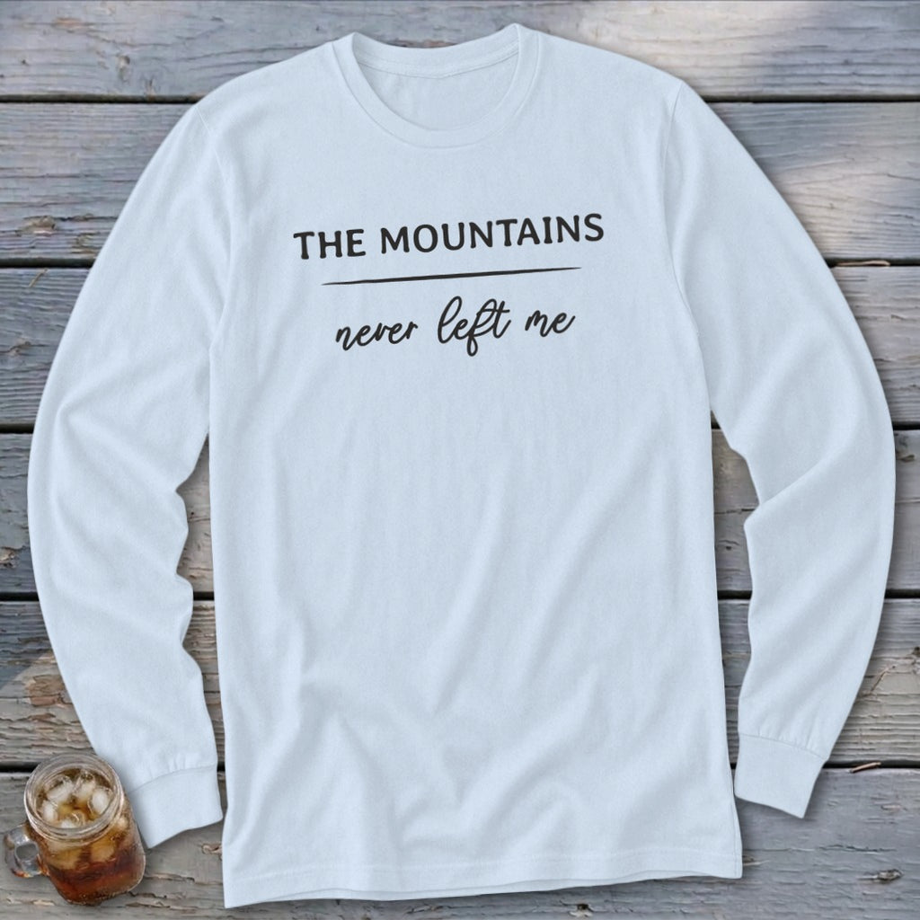 White long-sleeved shirt with black text that reads "THE MOUNTAINS never left me".