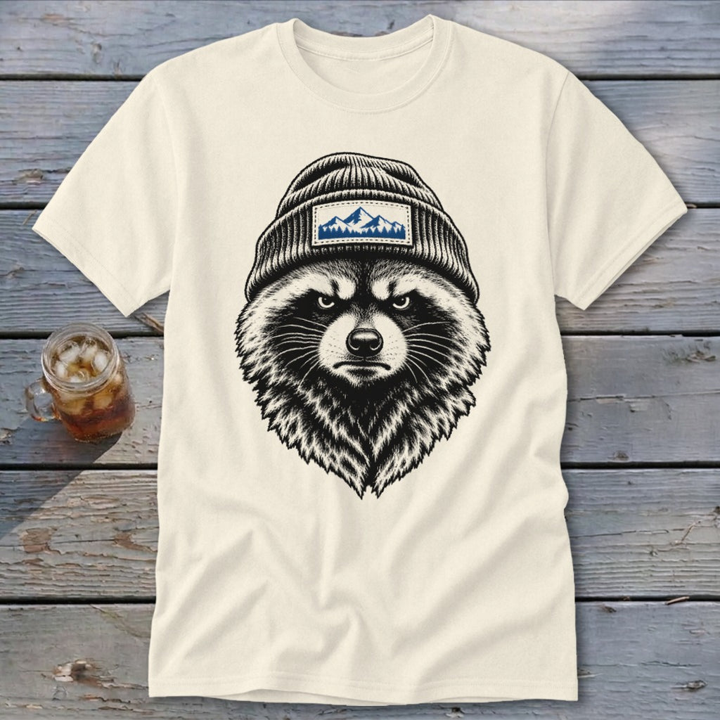 Cream t-shirt with a black and white illustration of a raccoon wearing a beanie with mountains.