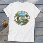 White t-shirt with circular graphic of Mississippi landscape, river, and deer.