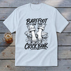 T-shirt graphic: Barefoot on the Crick Bank with feet in water.
