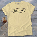 Yellow t-shirt with oval graphic that reads "THEY LAW".