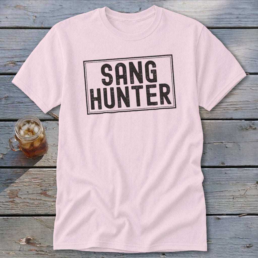 Pink t-shirt with black text in a rectangle reading "SANG HUNTER".