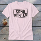 Pink t-shirt with black text in a rectangle reading "SANG HUNTER".