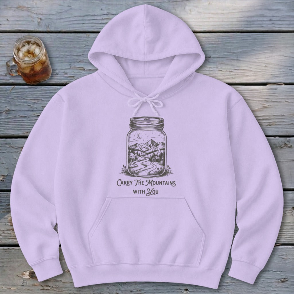 Light purple hooded sweatshirt featuring a jar graphic with mountain scenery and text reading Carry The Mountains With You.