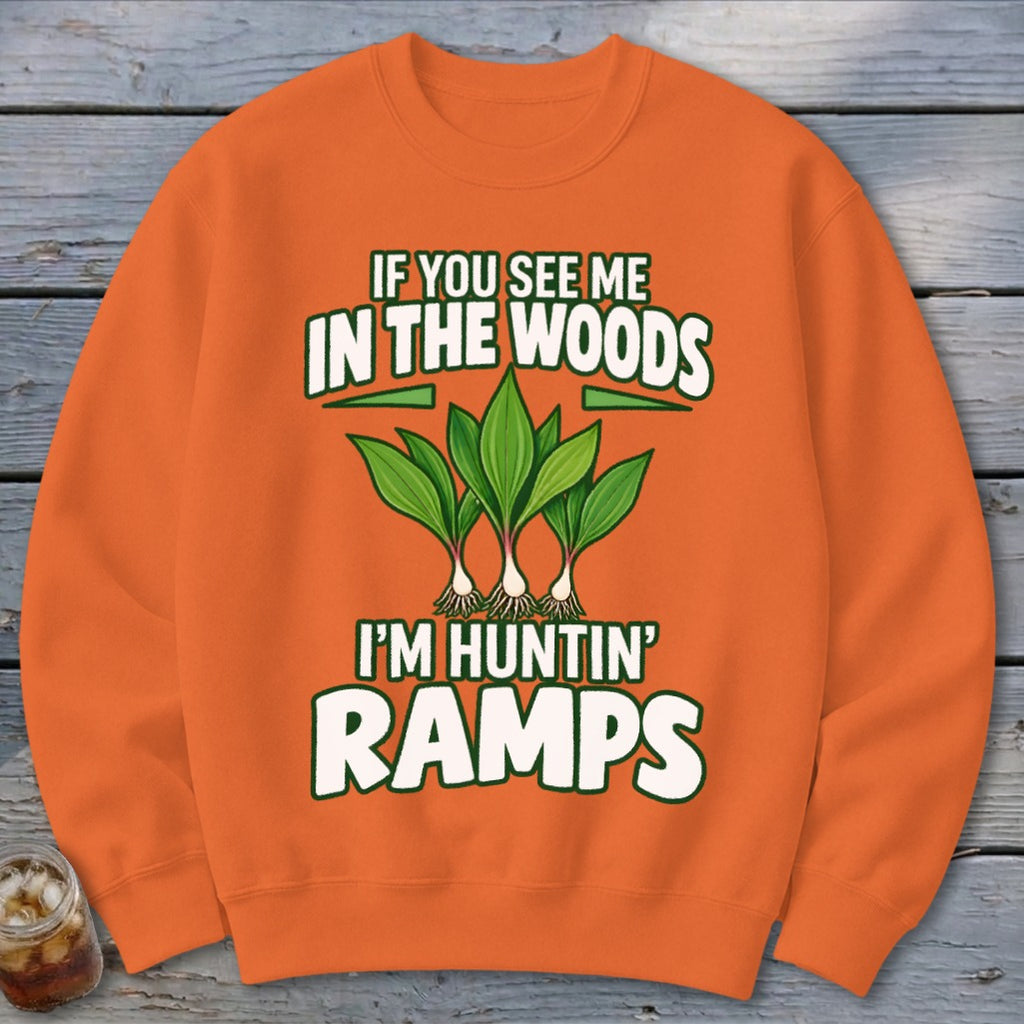 An orange sweatshirt with green text and ramps illustration, reading "IF YOU SEE ME IN THE WOODS I'M HUNTIN' RAMPS".