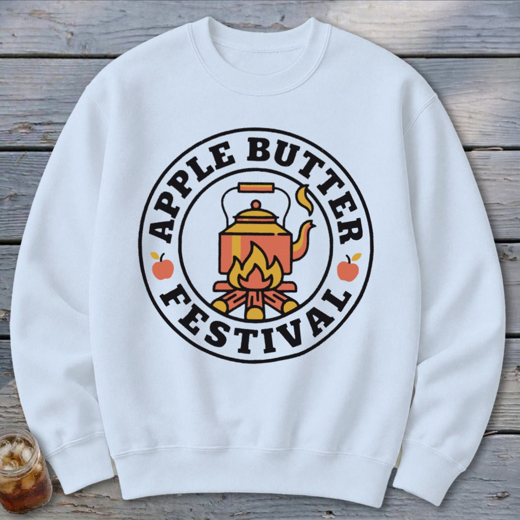 White sweatshirt with circular "Apple Butter Festival" logo featuring a kettle over a campfire.