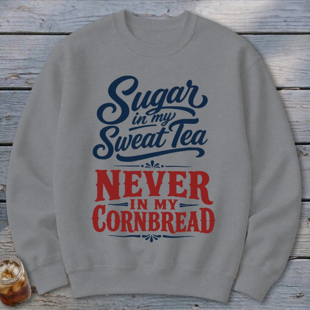 A gray crewneck sweatshirt printed with the text Sugar in my Sweat Tea, Never in my Cornbread in blue and red.
