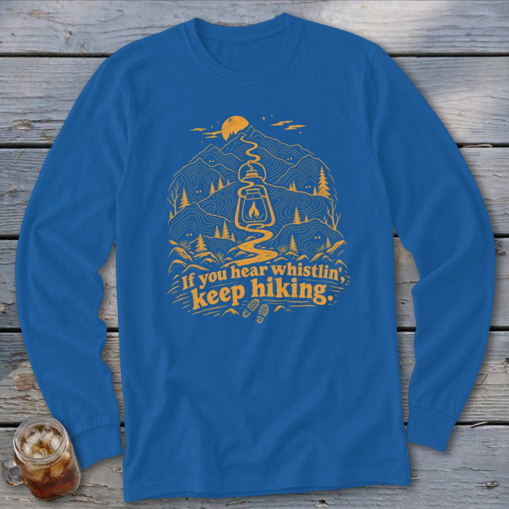 Blue long sleeve shirt with yellow graphic of mountains, lantern, and text "If you hear whistlin', keep hiking."