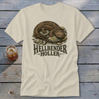 Cream t-shirt with Hellbender Holler text and illustration of a hellbender salamander on rocks.