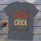 T-shirt with weathered sign reading "CREEK" crossed out, "CRICK" checked off.