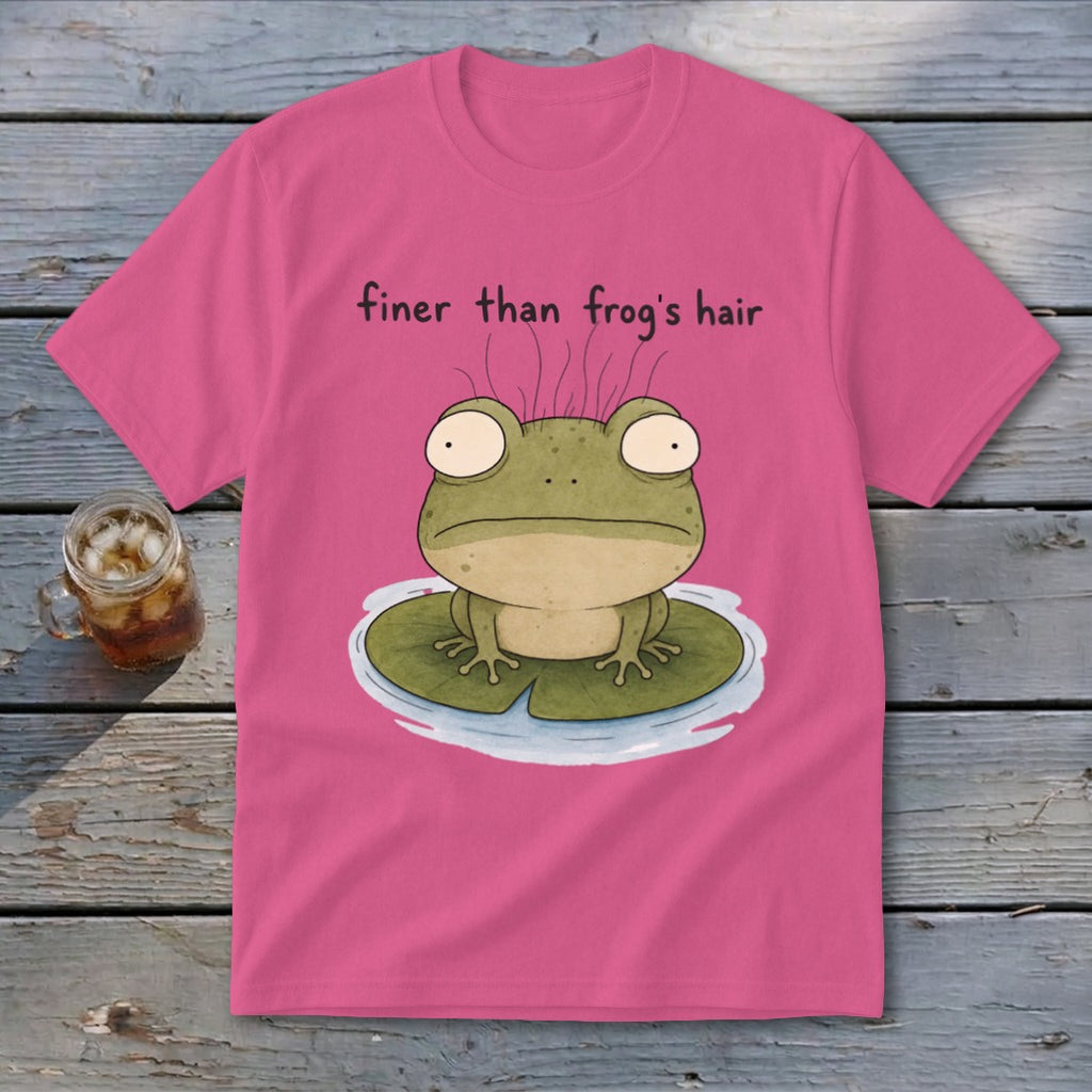 A pink t-shirt featuring a cartoon frog on a lily pad with the text finer than frog's hair.