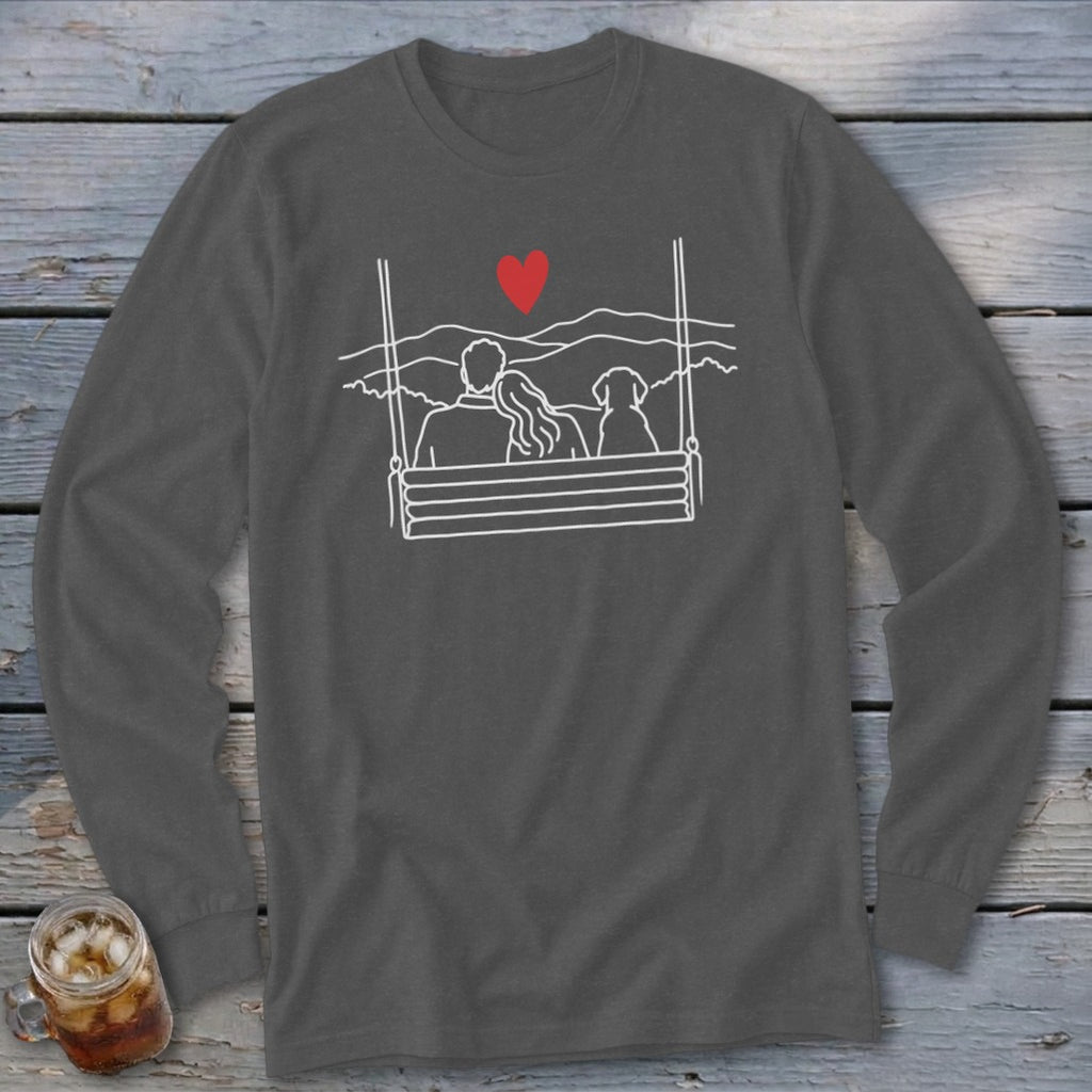 Line art of couple and dog on swing with heart and mountains above.