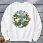 White sweatshirt with a circular Tennessee landscape graphic featuring mountains, river, deer, and sun.