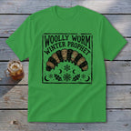 Bright green crewneck t-shirt featuring a black graphic of a woolly worm and the text Woolly Worm Winter Prophet.