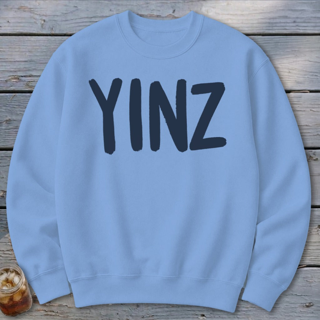 Light blue crewneck sweatshirt with "YINZ" in dark blue lettering.