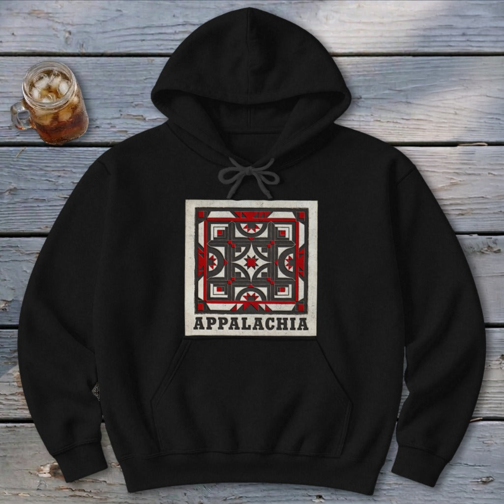 Black hoodie featuring a square geometric quilt pattern and the word Appalachia on a rustic wooden background.