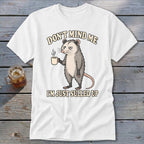 White t-shirt with an opossum holding coffee and text "DON'T MIND ME I'M JUST SULLED UP."