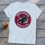 A white t-shirt featuring a maroon graphic of a bear lounging on a porch swing, surrounded by the text PROFESSIONAL PORCH SITTER.