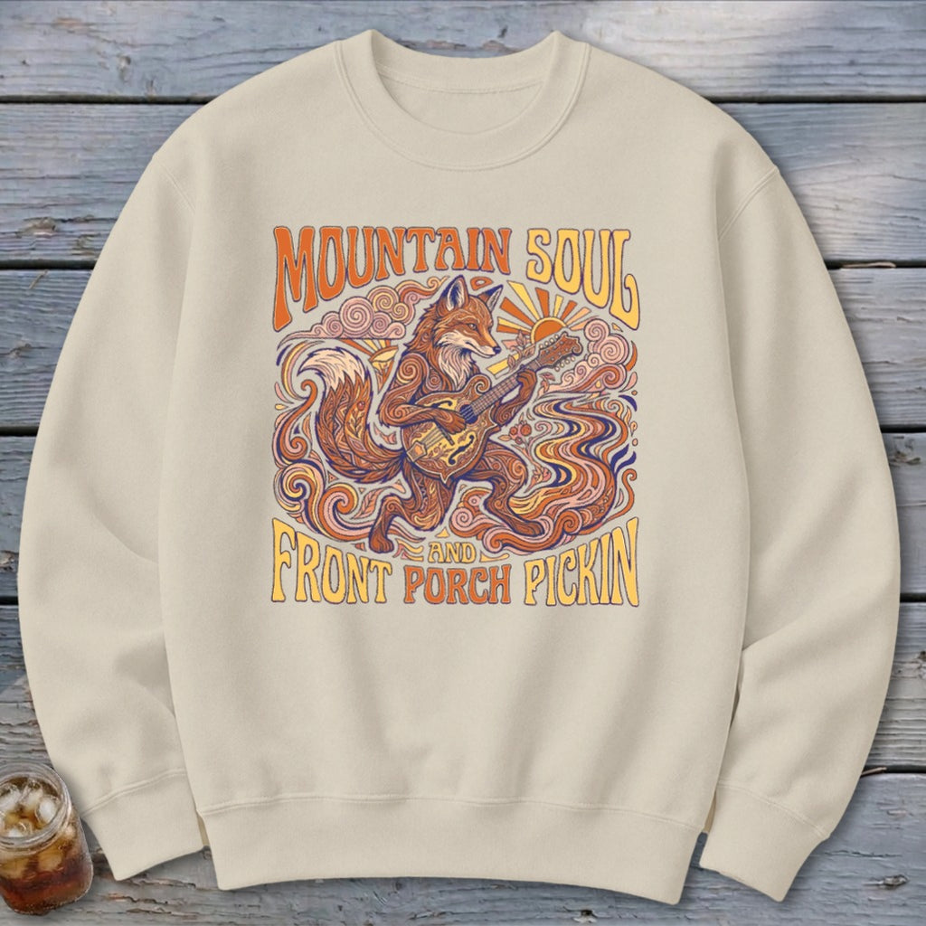 Cream sweatshirt with a stylized fox playing a guitar and text "Mountain Soul and Front Porch Pickin'".