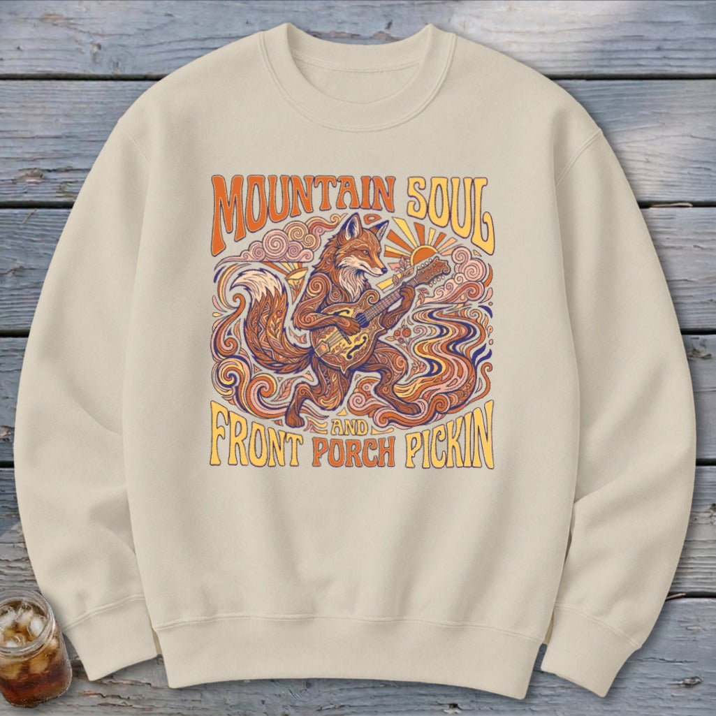 Cream sweatshirt with a stylized fox playing a guitar and text "Mountain Soul and Front Porch Pickin'".