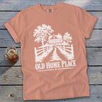T-shirt with white graphic of a farmhouse, trees, fence, and text "OLD HOME PLACE".