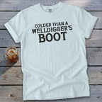 White t-shirt with "Colder Than A Welldigger's Boot" text and glass of iced tea.