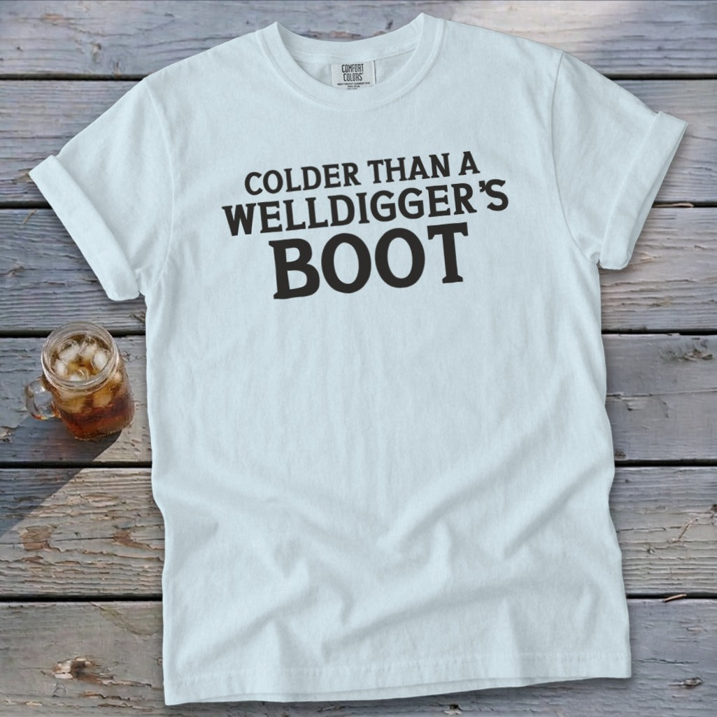 White t-shirt with "Colder Than A Welldigger's Boot" text and glass of iced tea.