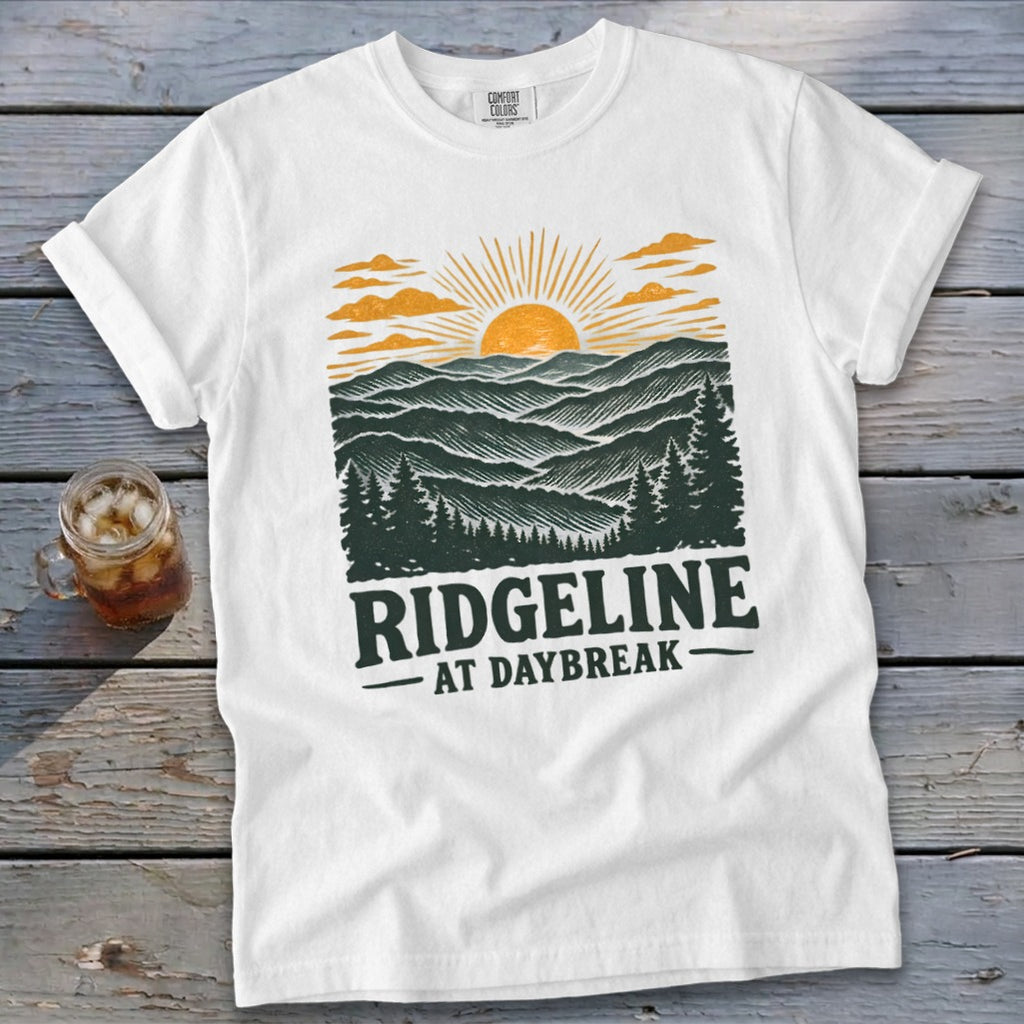 White t-shirt with Ridgeline At Daybreak graphic featuring mountains, trees, and sunrise.