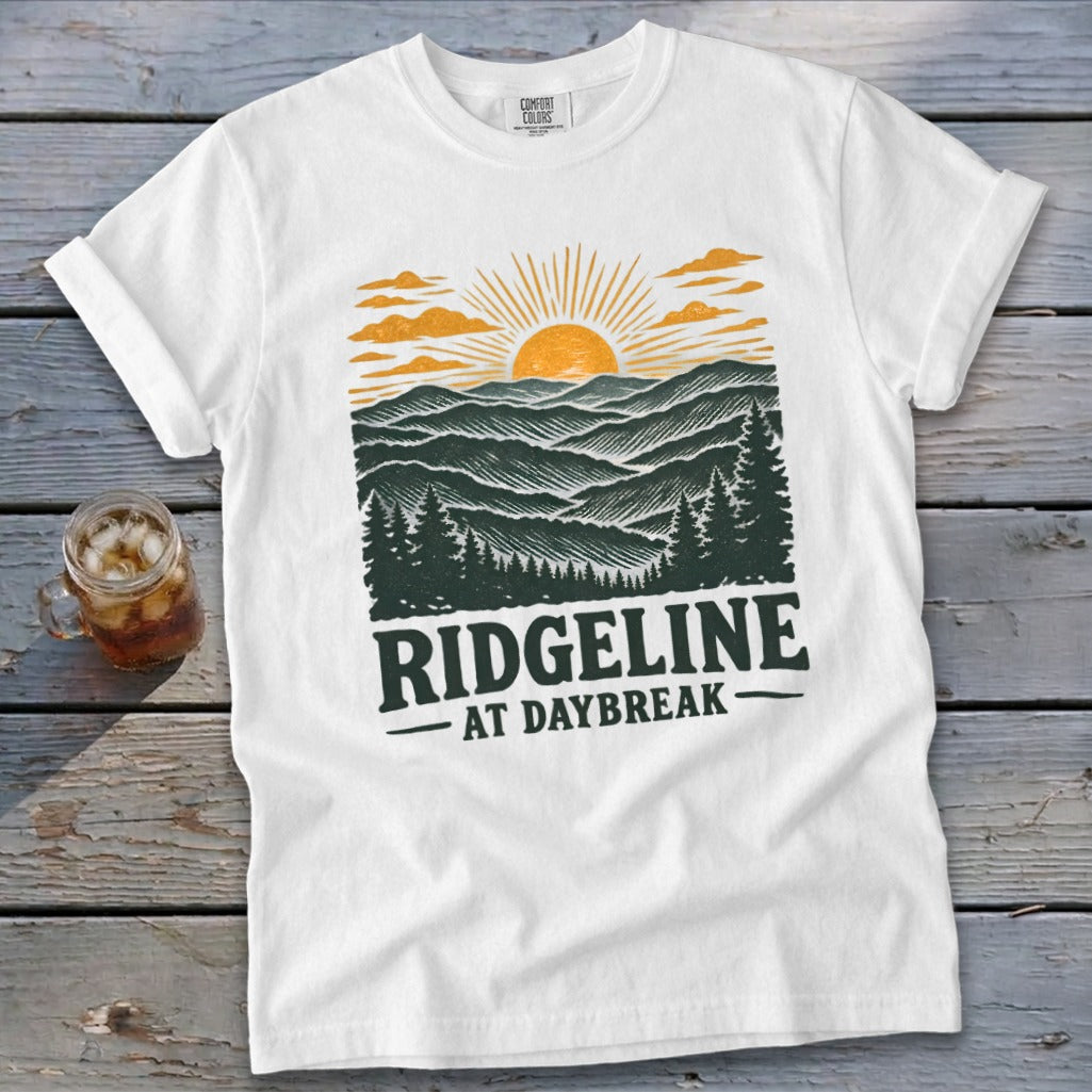 White t-shirt with Ridgeline At Daybreak graphic featuring mountains, trees, and sunrise.