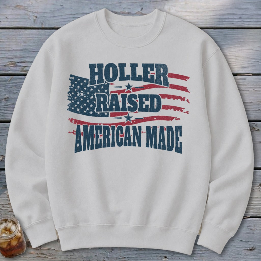 White sweatshirt with "Holler Raised American Made" text and distressed American flag graphic.