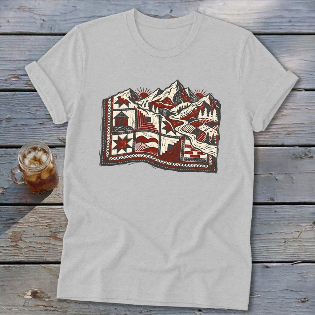 Light gray t-shirt featuring a stylized graphic of a red and white quilt blending into a mountain landscape.