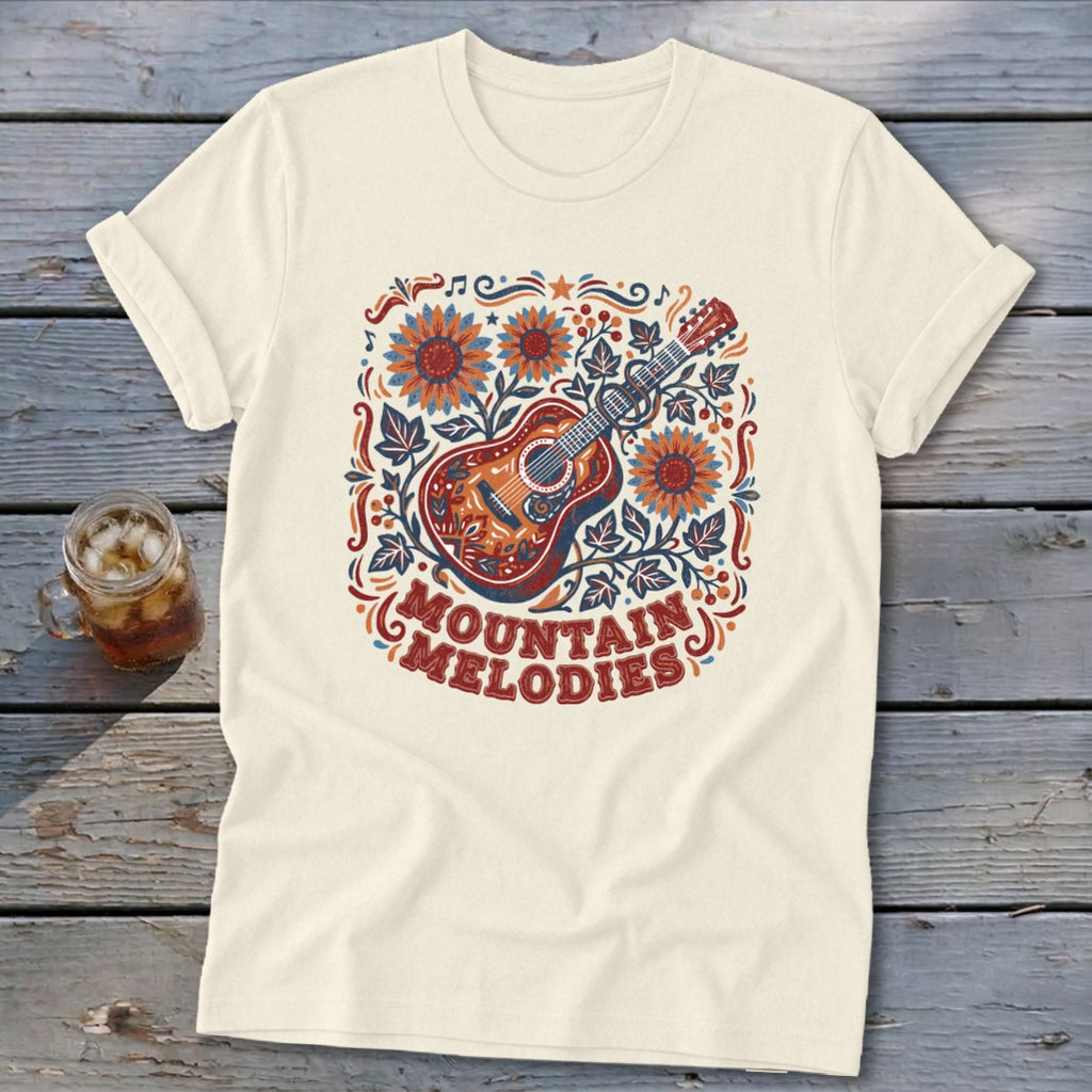 Cream t-shirt featuring a folk-art acoustic guitar graphic, sunflowers, and the text Mountain Melodies.