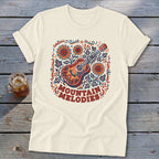 Cream t-shirt featuring a folk-art acoustic guitar graphic, sunflowers, and the text Mountain Melodies.