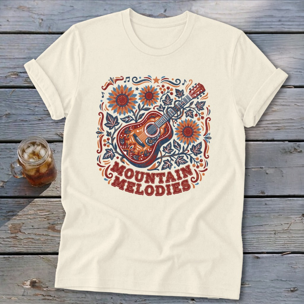 Cream t-shirt featuring a folk-art acoustic guitar graphic, sunflowers, and the text Mountain Melodies.