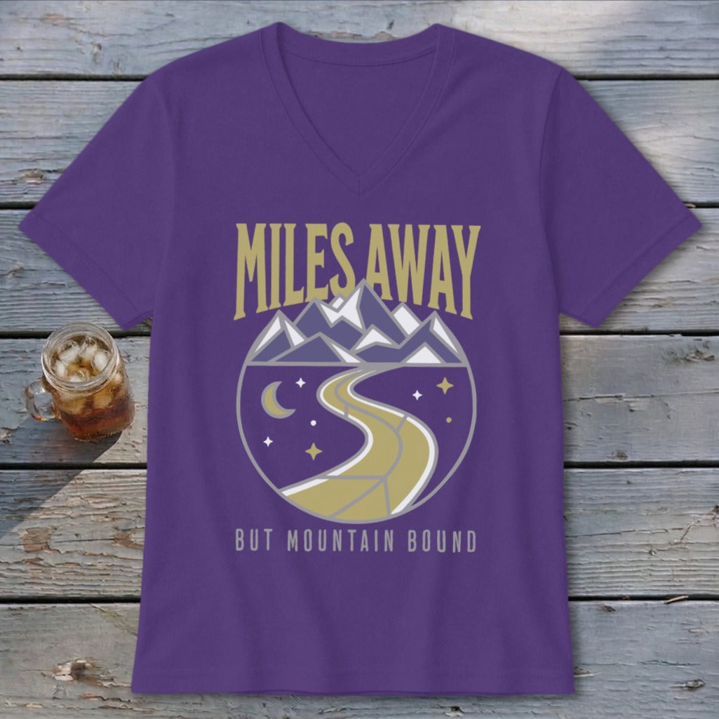 Purple t-shirt with "Miles Away But Mountain Bound" text and mountain road design.