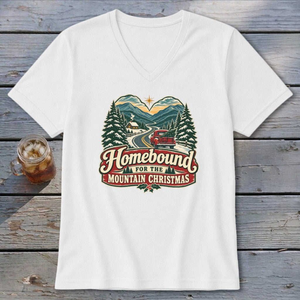 White v-neck t-shirt featuring "Homebound for the Mountain Christmas" with a vintage truck and snowy landscape design.